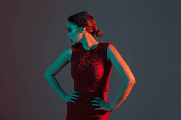 elegant feminine girl looking to the side with colored light - Foto, Imagem