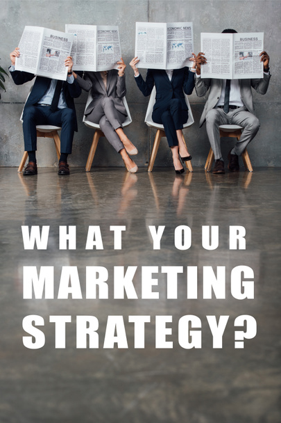 businesspeople sitting on chairs and holding newspapers in front of faces in waiting hall with what your marketing strategy question on floor   - Foto, Imagem