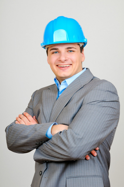 Happy businessman with blue hard hat standing confidently isolated on white background - Fotoğraf, Görsel