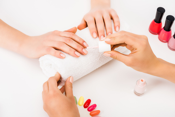 Cropped view of manicurist using nail polish and nail palette - 写真・画像