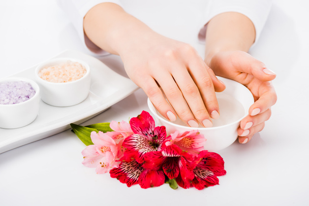 Partial view of woman taking nail bath with flowers - Foto, Imagem