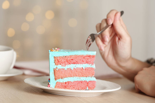 Woman eating fresh delicious birthday cake at table, closeup - Foto, immagini