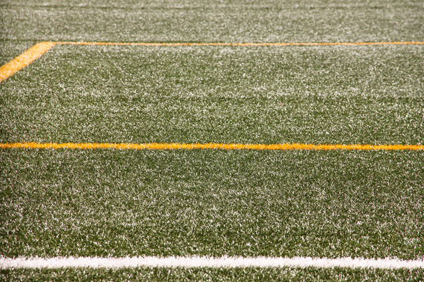 Part of sport soccer stadium and artificial turf football field. Detail, close up of green grass with white lines, goal line, corner line. Focus football field selected background, texture, wallpaper. - Fotoğraf, Görsel