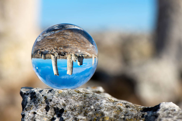 Upside down landscape of Pobiti Kamani, The Stone Forest Natural Reserve near Varna in Bulgaria, Eastern Europe - reflection in a lens ball - selective focus, space for text - Photo, Image