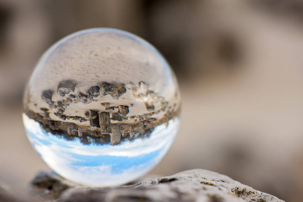 Upside down landscape of Pobiti Kamani, The Stone Forest Natural Reserve near Varna in Bulgaria, Eastern Europe - reflection in a lens ball - selective focus, space for text - Photo, Image