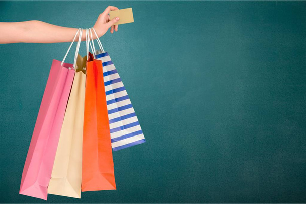 female hand holding shopping bags and credit card - Photo, Image