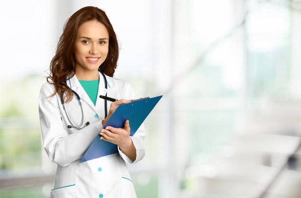 Young female doctor on background - Foto, Imagen