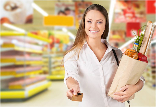 happy young woman doing shopping at supermarket  - Фото, изображение