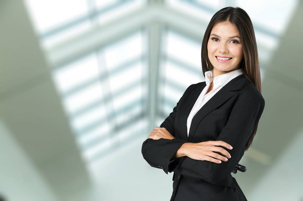 Portrait of young businesswoman in suit on background - Foto, Imagem