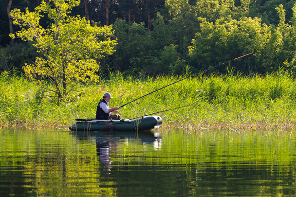 Petropavlovsk, Kazakhstan - July 28, 2018: Fishermen, people on rubber boats on the lake fish. Lake Pestroe, Petropavlovsk, Kazakhstan. - 写真・画像