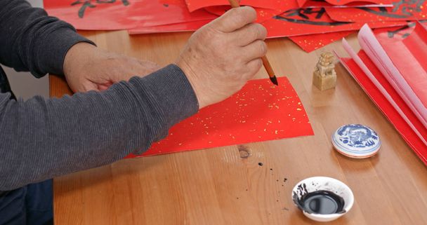 Man write chinese calligraphy for lunar new year - Photo, Image