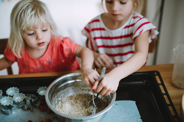 zwei süße kleine Schwestern kochen zu Hause - Foto, Bild