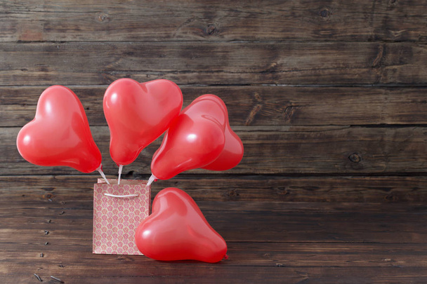 heart shaped red  balloons on old wooden background - Zdjęcie, obraz