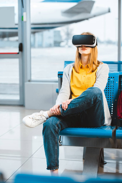 woman wearing virtual reality headset while waiting in airport - Foto, Imagem
