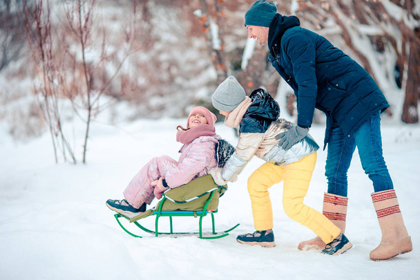 Family of dad and kids vacation on Christmas eve outdoors - 写真・画像