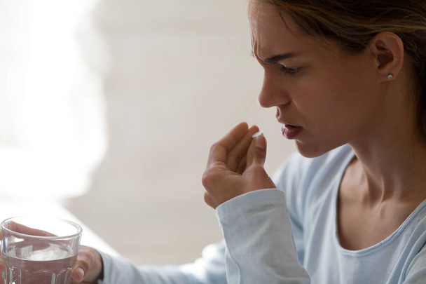Close up unhealthy woman hold glass still water and pill - Φωτογραφία, εικόνα