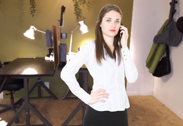 cheerful businesswoman in phone with customers at office pretty - Фото, изображение