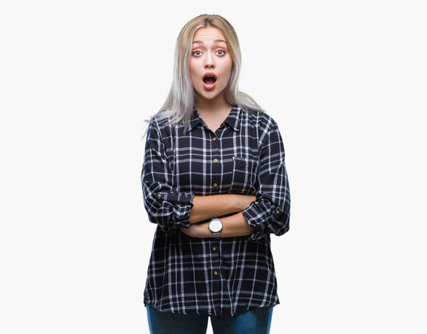 Young blonde woman over isolated background afraid and shocked with surprise expression, fear and excited face. - Photo, Image