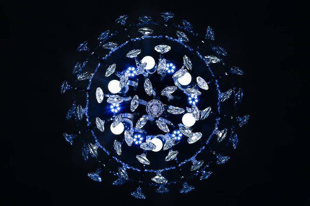Bottom view of a crystal chandelier with shiny crystals - Zdjęcie, obraz