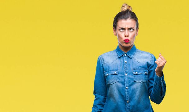 Young beautiful woman over isolated background making fish face with lips, crazy and comical gesture. Funny expression. - Фото, изображение