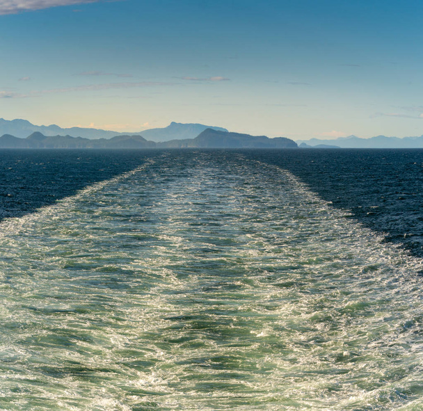Sunny bright panorama of turbulent ship wash in the vast ocean channel of Stephens Passage, Alaska, USA Inside Passage. - Foto, afbeelding