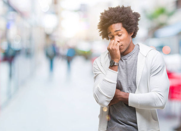 Afro american man wearing sweatshirt over isolated background looking stressed and nervous with hands on mouth biting nails. Anxiety problem. - Foto, imagen