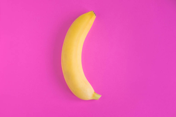 Conceptual photo of a banana on a pink background. Banana photo for advertising - Fotó, kép