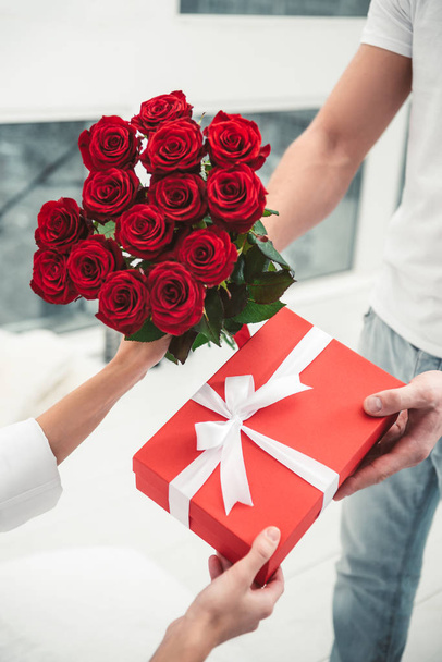 close up of man giving present and flowers for girlfriend, valentines day concept - Fotó, kép