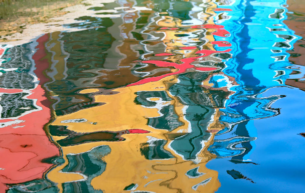 colored reflections of the Venetian houses on the water of the canal in Italy - Photo, Image