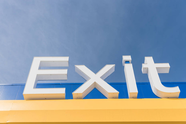 Low-angle view of Exit sign again blue sky - Photo, Image