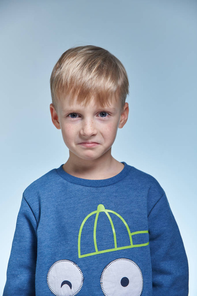 portrait of funny emotional boy in studio 7 years old, positive scare - Foto, Imagem