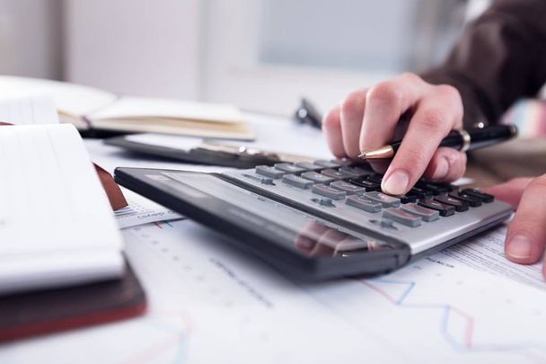 Accountant man  with calculator and documents - Fotoğraf, Görsel