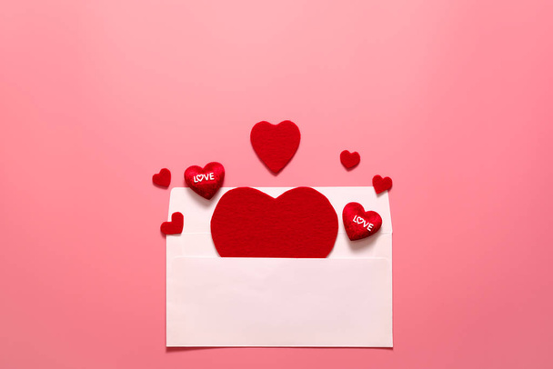 Valentinstag-Konzept, rote Herzen weißer Umschlag auf rosa Hintergrund - Foto, Bild