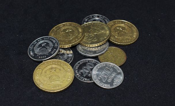 Monnaies vietnamiennes sur fond noir
  - Photo, image