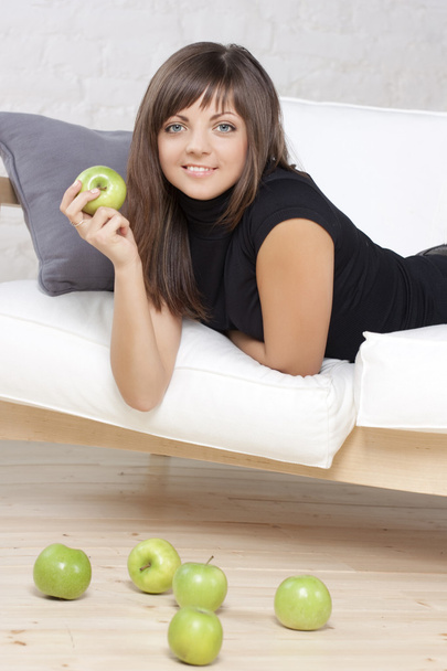 Beautiful smiling girl with green apples - 写真・画像