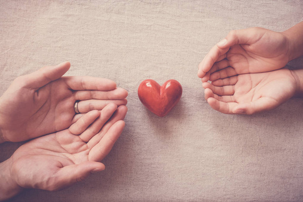 hands and red heart, health insurance, donation and charity concept  - Photo, Image