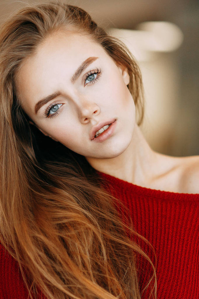 Beautiful Russian girl in a red jacket. Emotional portraits with a cute face. - 写真・画像