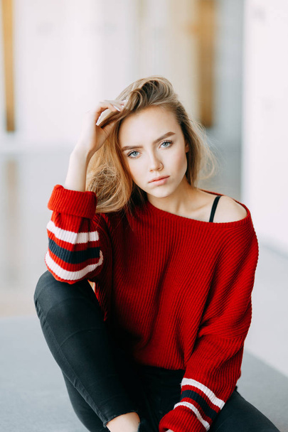 Beautiful Russian girl in a red jacket. Emotional portraits with a cute face. - Photo, Image