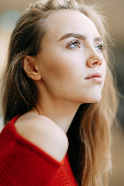 Beautiful Russian girl in a red jacket. Emotional portraits with a cute face. - Foto, immagini