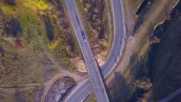 Nature. Flight over the highway near the forest, road junction near the railway from height, cars traffic on the highway. - Footage, Video