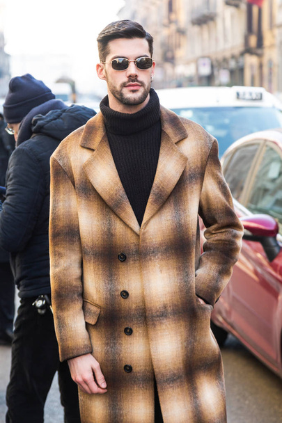 MILAN, ITALY - JANUARY 13: Fashionable man poses outside John Richmond fashion show during Milan Men's Fashion Week on JANUARY 13, 2019 in Milan. - Zdjęcie, obraz