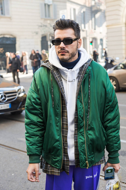 MILAN, ITALY - JANUARY 13: Fashionable man poses outside John Richmond fashion show during Milan Men's Fashion Week on JANUARY 13, 2019 in Milan. - Fotó, kép