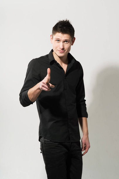 Portrait of young caucasian man in black shirt posing on white background - Photo, Image