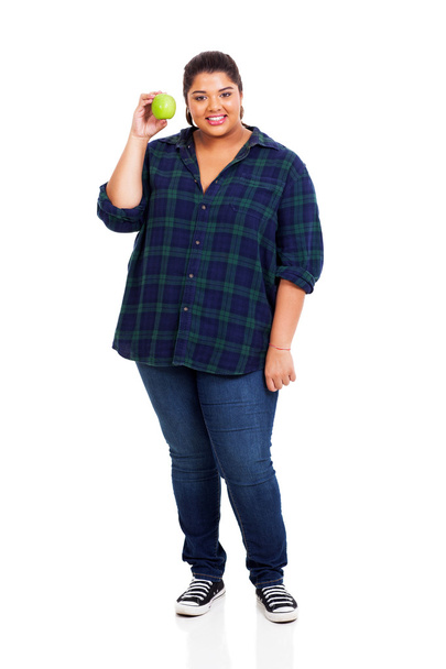 smiling overweight woman holding green apple - Foto, Imagen