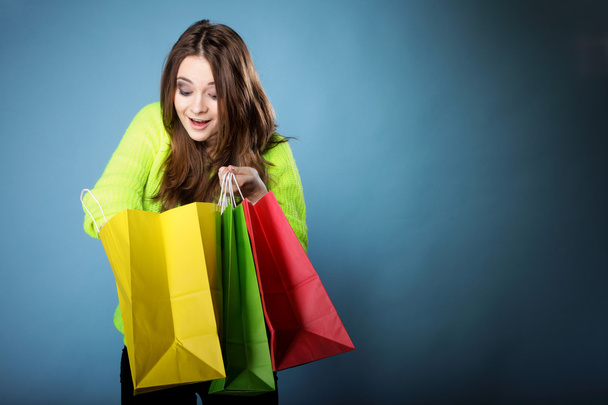 Surprised girl with paper shopping bag. Sales. - Photo, Image