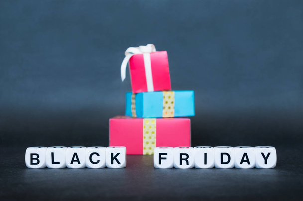 Sale banner with text word Black Friday and multicolored gift boxes. Black Friday sale mockup - Фото, изображение