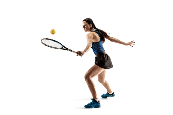 Full length portrait of young woman playing tennis isolated on white background - Foto, immagini