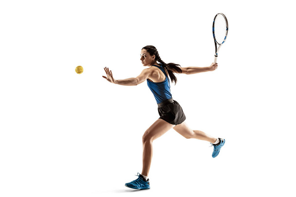 Full length portrait of young woman playing tennis isolated on white background - Photo, image