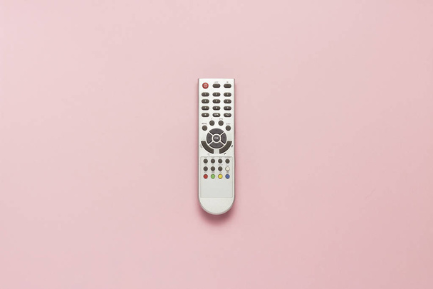 Gray remote control on a pink background. The concept of television, movies, TV shows, sports, day and night. Flat lay, top view - Photo, Image