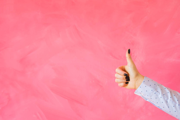 空のピンクの背景に手ジェスチャー親指を示す人 - 写真・画像